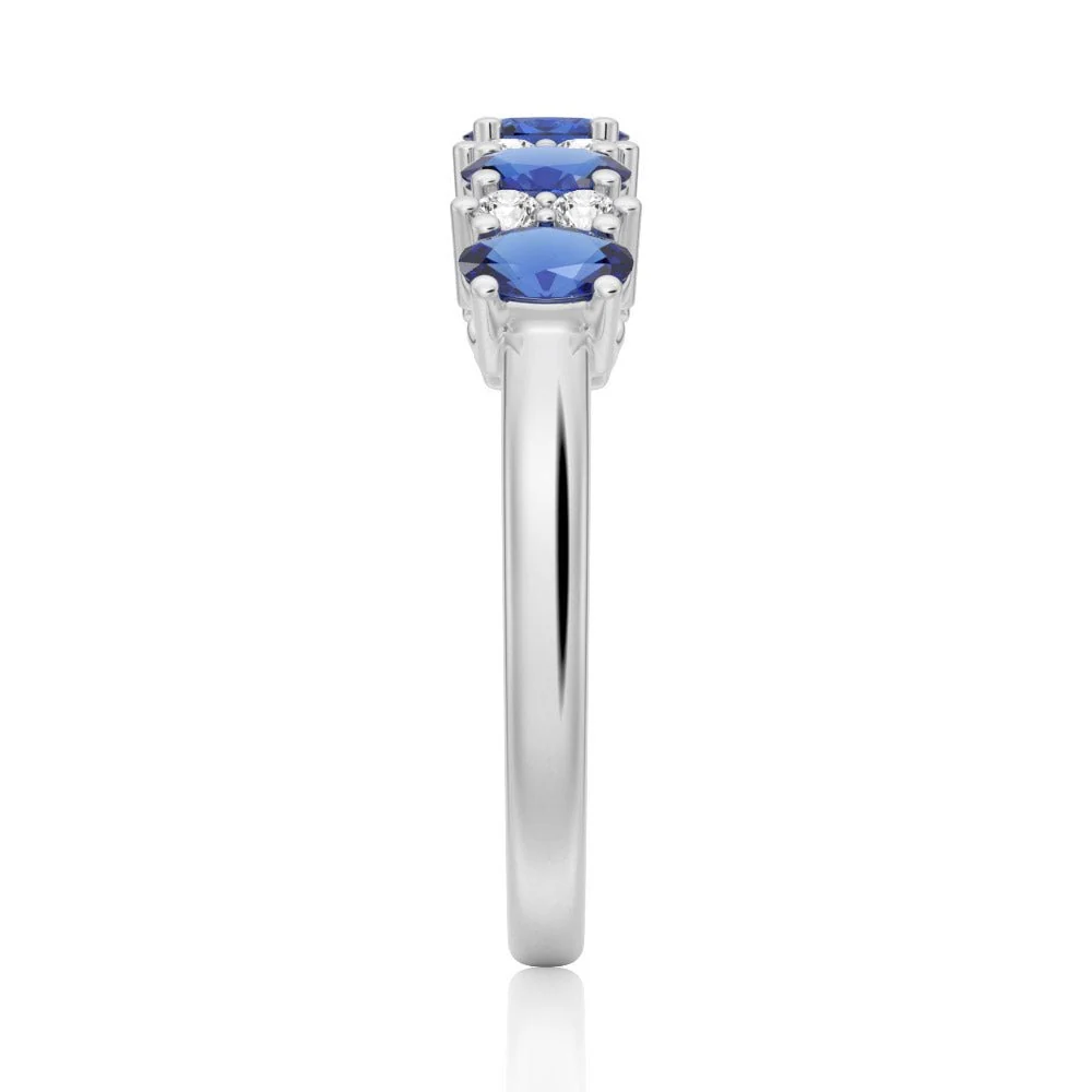 Side view of 2mm shared prong band showing alternating oval blue and round white sapphires