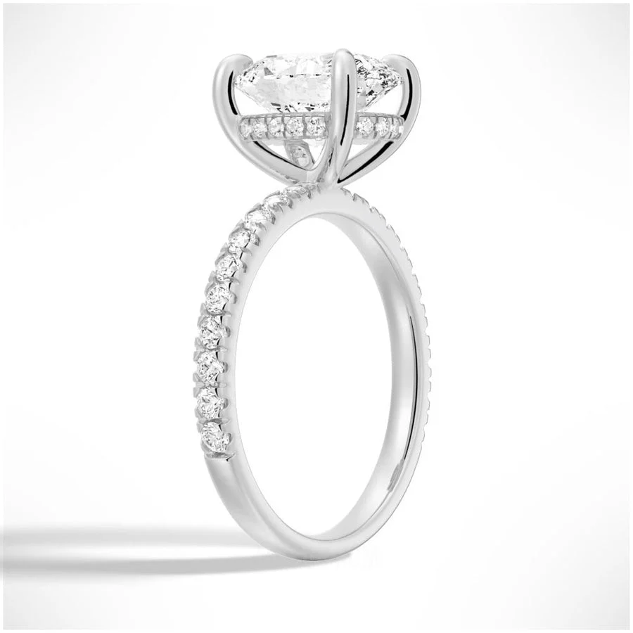 Angled profile view of Oval Cut Moissanite Engagement Ring with Hidden Halo & Pavé Band and 4 Prong Setting in White Gold 