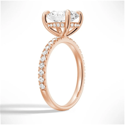 Angled profile view of Oval Cut Moissanite Engagement Ring with Hidden Halo & Pavé Band and 4 Prong Setting in Rose Gold