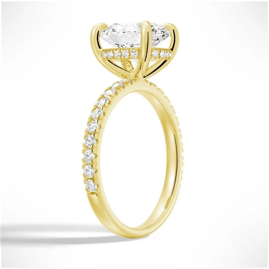 Angled profile view of Oval Cut Moissanite Engagement Ring with Hidden Halo & Pavé Band and 4 Prong Setting in Yellow Gold 