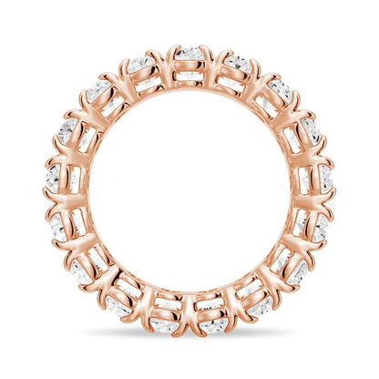 Side circular profile view of rose gold oval cut moissanite eternity ring