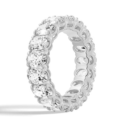 Three quarter angled view of white gold shared prong oval moissanite eternity ring