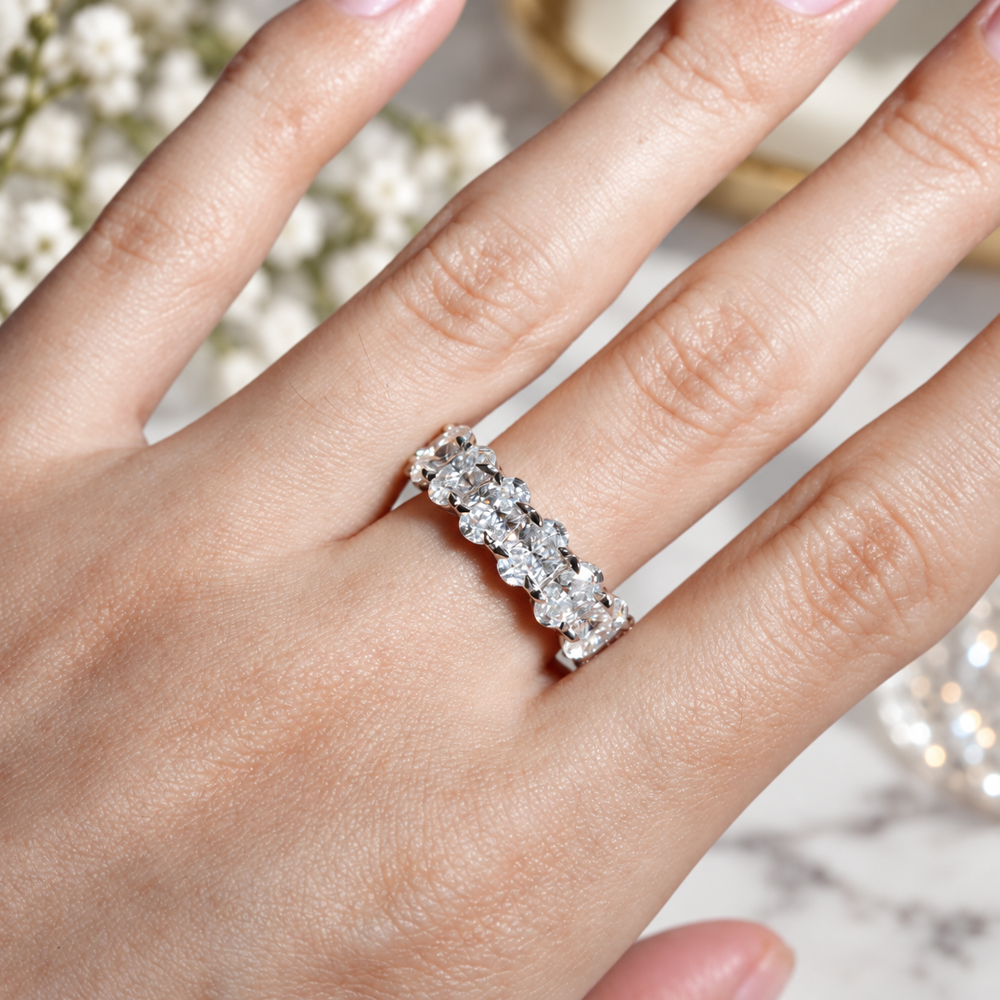 Real-life on-hand view of white gold oval cut moissanite full eternity ring