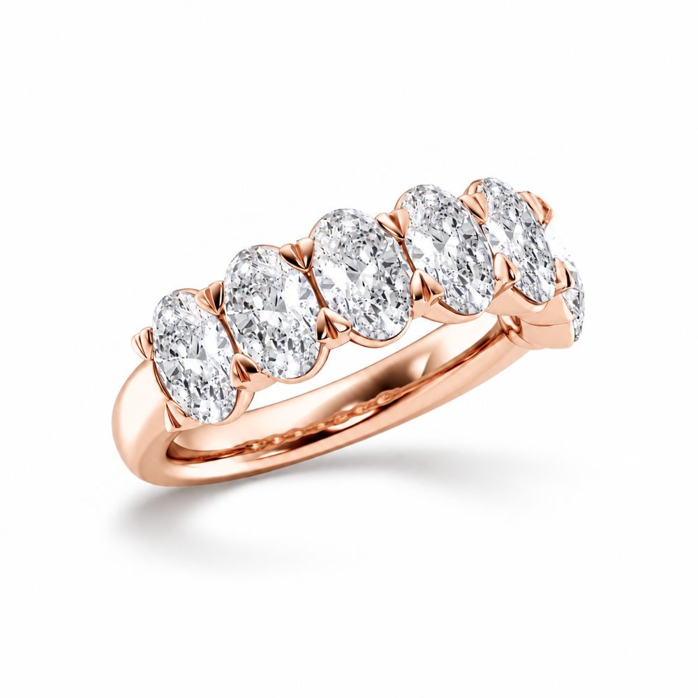 Three quarter view of rose gold oval cut moissanite half eternity ring
