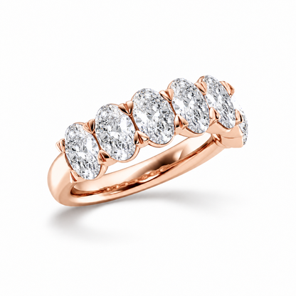Three quarter view of rose gold oval cut moissanite half eternity ring