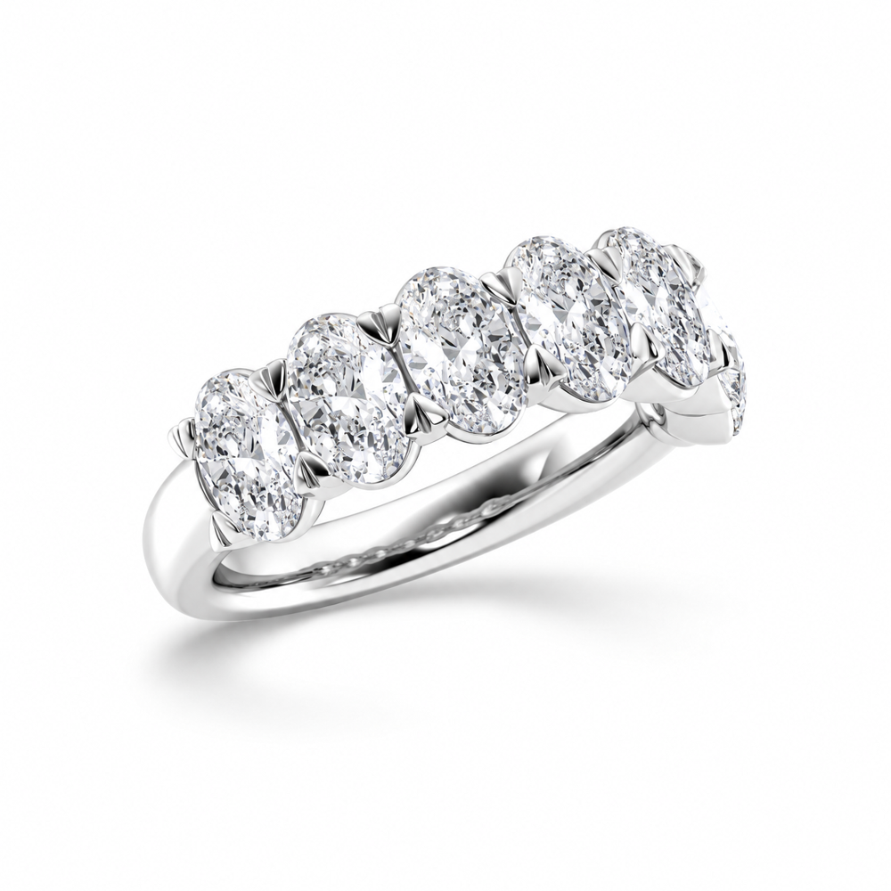Three quarter angled view of white gold oval cut moissanite half eternity ring