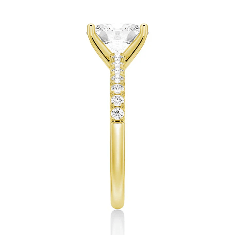 Side profile view of Petite Oval Moissanite Engagement Ring with Micropavé Band in Yellow Gold