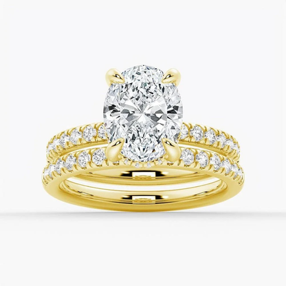 Yellow gold oval moissanite bridal set with pave engagement ring and matching wedding band