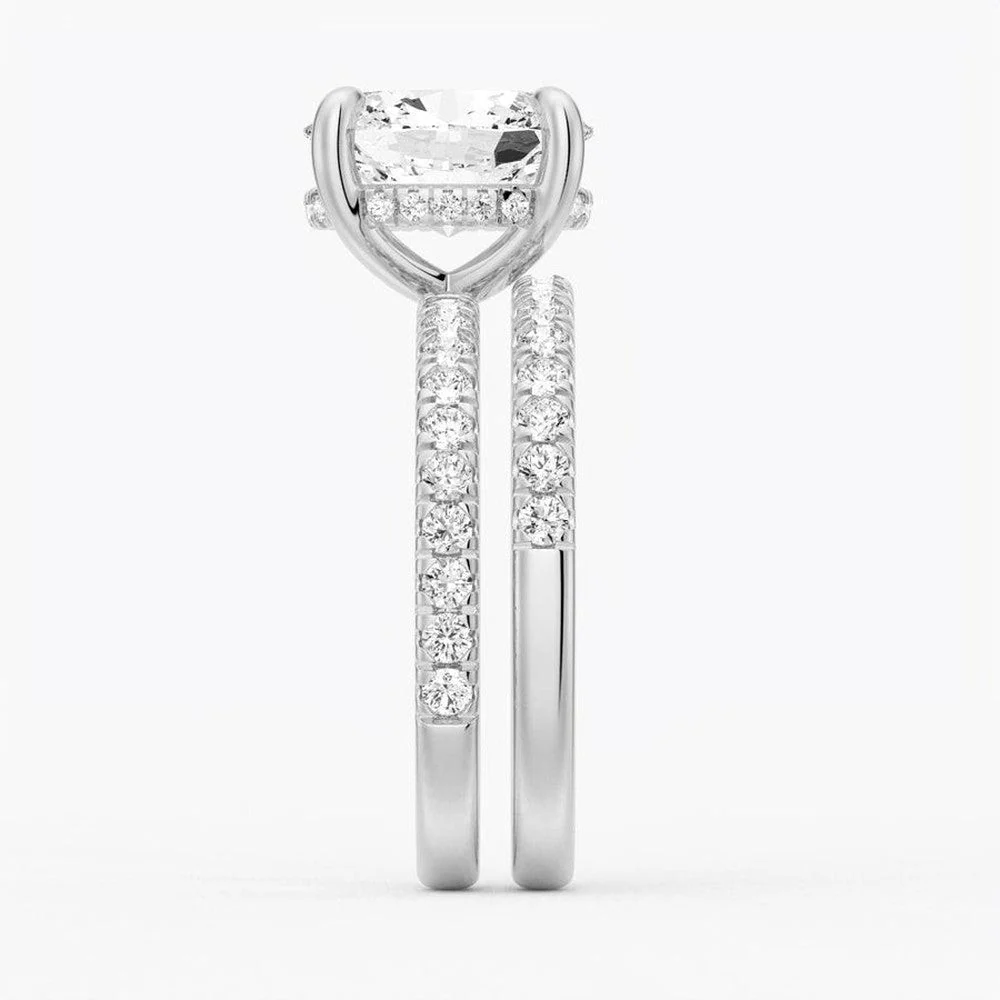 White gold oval moissanite bridal set side profile view showing stacked engagement ring and pave band