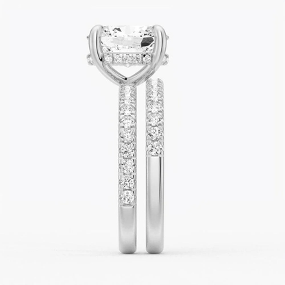 White gold oval moissanite bridal set side profile view showing stacked engagement ring and pave band