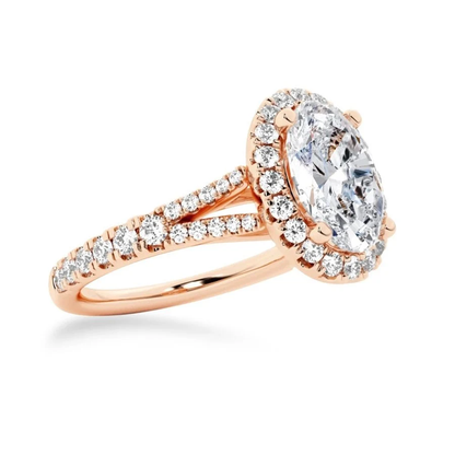 Rose gold oval moissanite halo engagement ring 3/4 angle view with pavé split shank