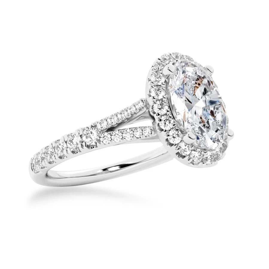 White gold oval moissanite halo engagement ring 3/4 perspective view showcasing split shank details
