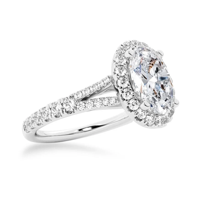 White gold oval moissanite halo engagement ring 3/4 perspective view showcasing split shank details