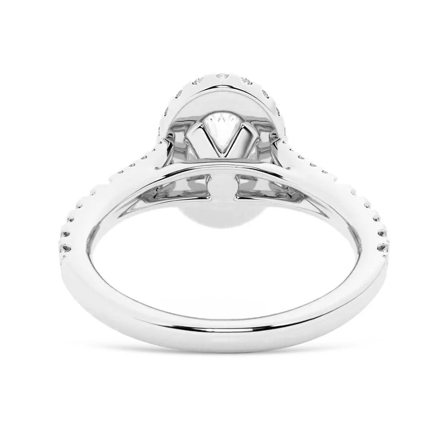 White gold oval halo moissanite ring close-up view displaying basket setting and pave band