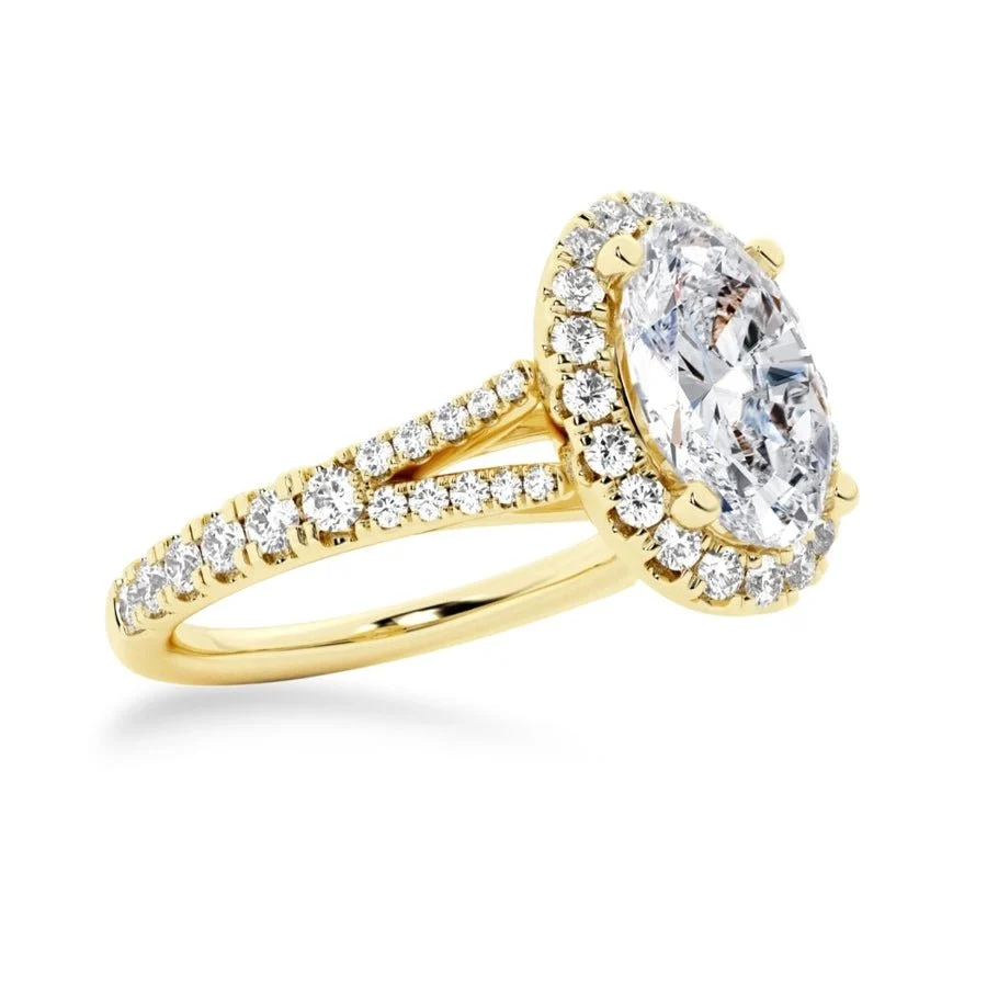 Yellow gold oval moissanite engagement ring 3/4 perspective view with halo and split pavé band