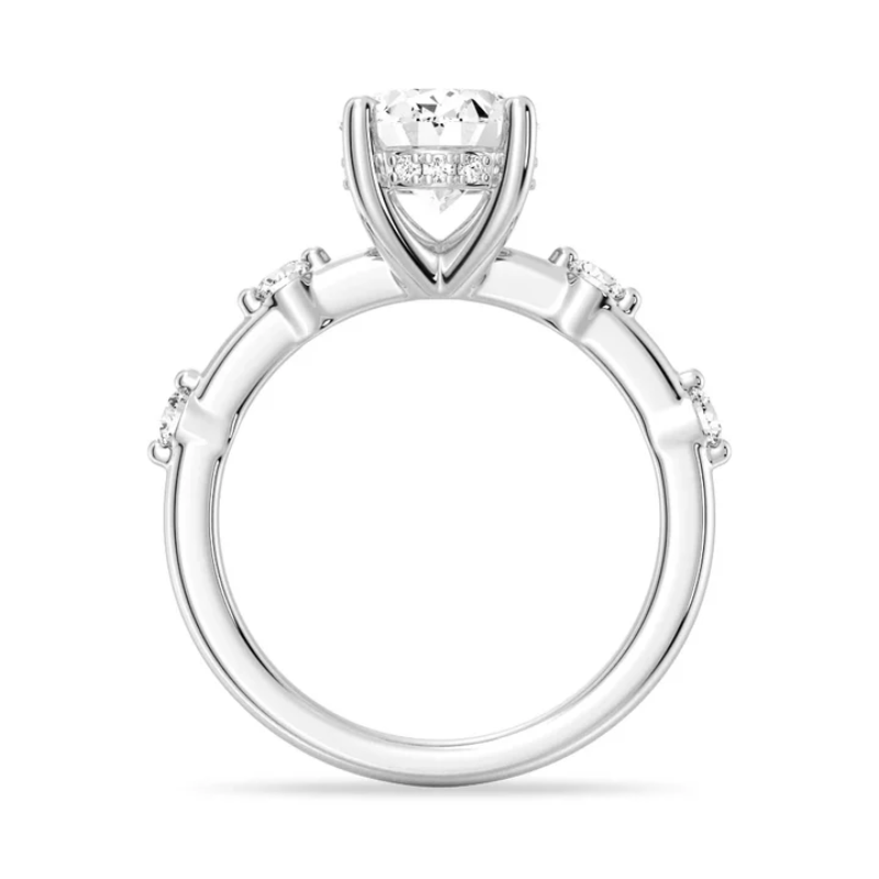 White gold oval moissanite engagement ring direct side profile view with hidden halo and spaced diamond band