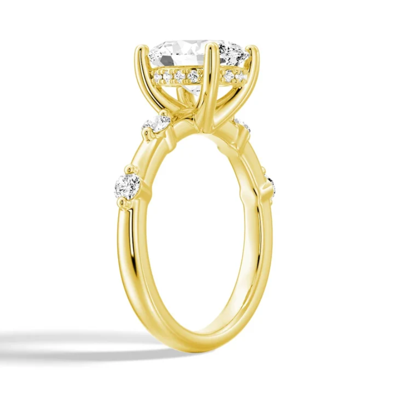 Yellow gold oval moissanite engagement ring 3/4 perspective view showing hidden halo setting