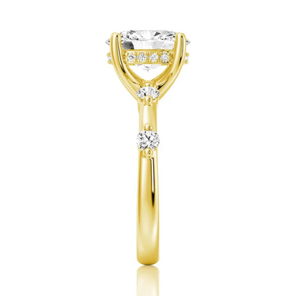 Yellow gold oval moissanite ring side view displaying bezel spaced stones along the band