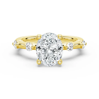 Yellow gold oval moissanite engagement ring top view with spaced accent stones on 1.5mm band