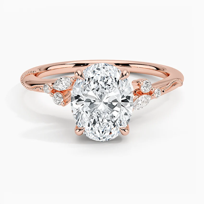 Rose gold oval moissanite engagement ring top view with organic marquise cluster accents