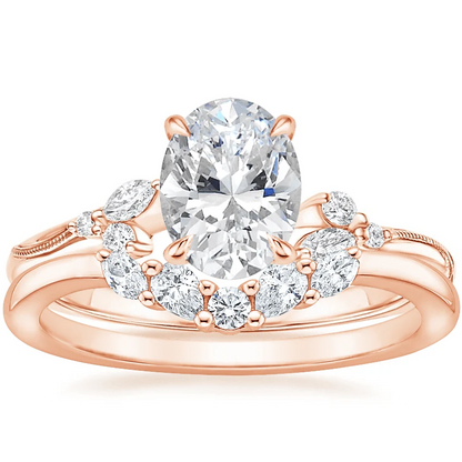 Rose gold oval moissanite engagement ring stacked with matching round and marquise wedding band