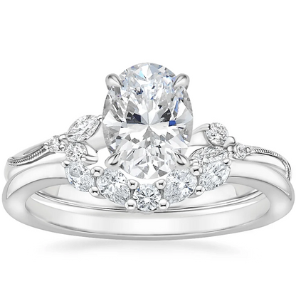 White gold oval moissanite engagement ring stacked with matching round and marquise wedding band