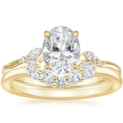 Yellow gold oval moissanite engagement ring stacked with matching round and marquise wedding band