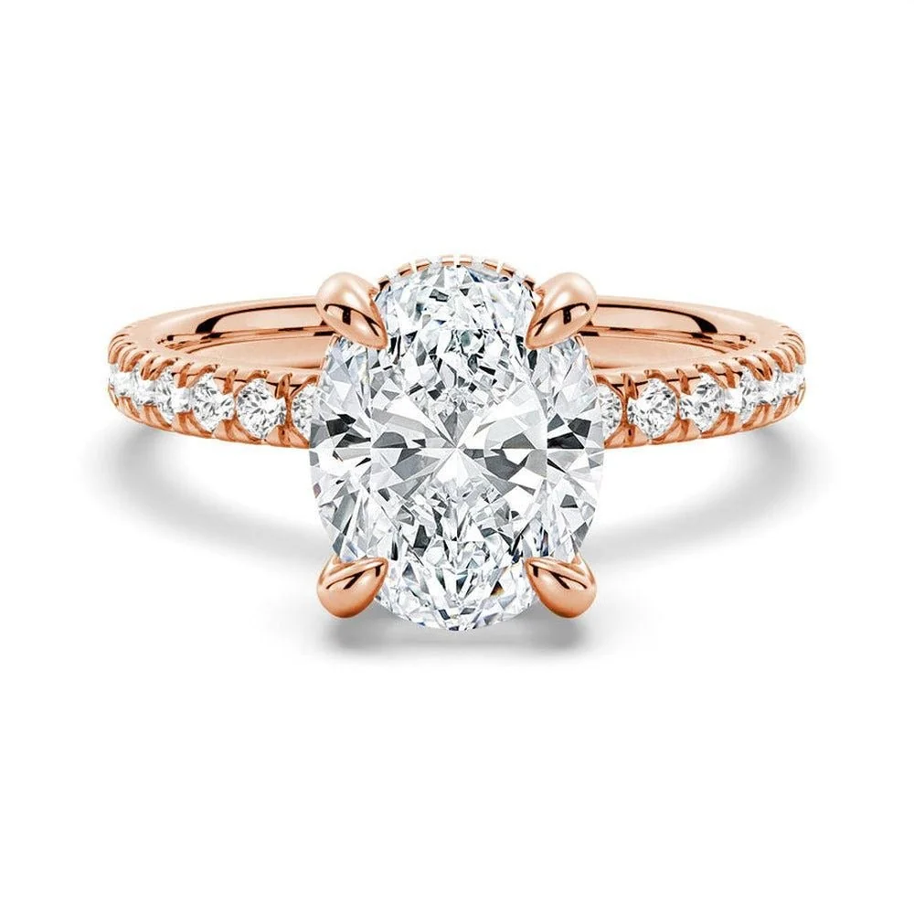 Rose gold oval cut moissanite engagement ring top view with pave band