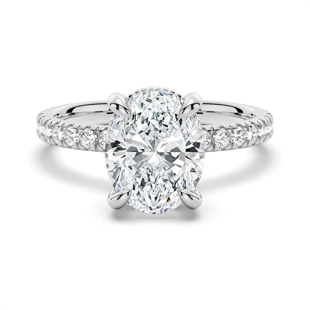 White gold oval cut moissanite engagement ring top view with pave band