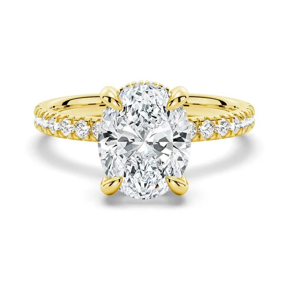 Yellow gold oval cut moissanite engagement ring top view with pave band