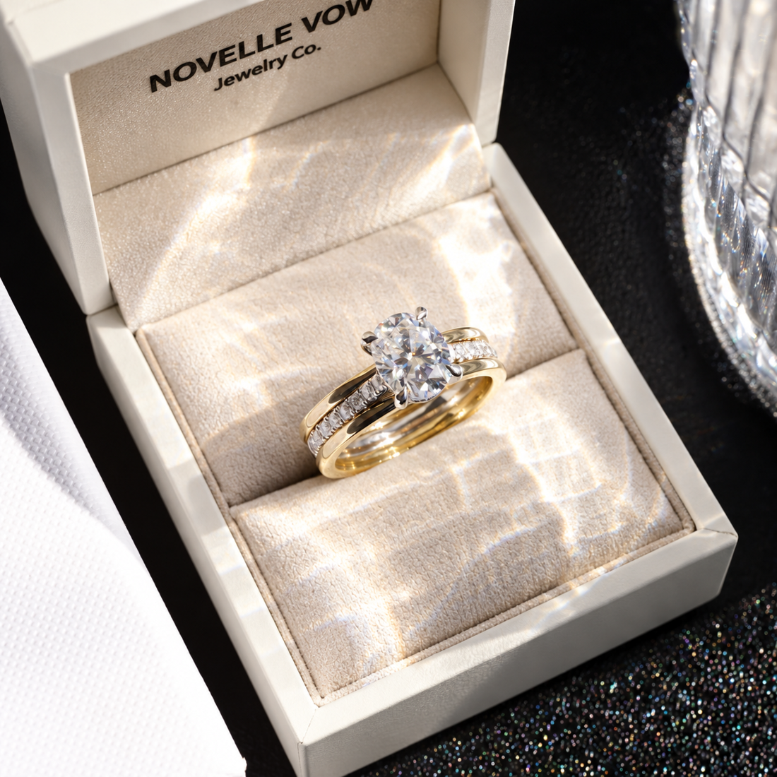 Two-tone yellow gold oval moissanite engagement ring presented inside Novelle Vow luxury ring box