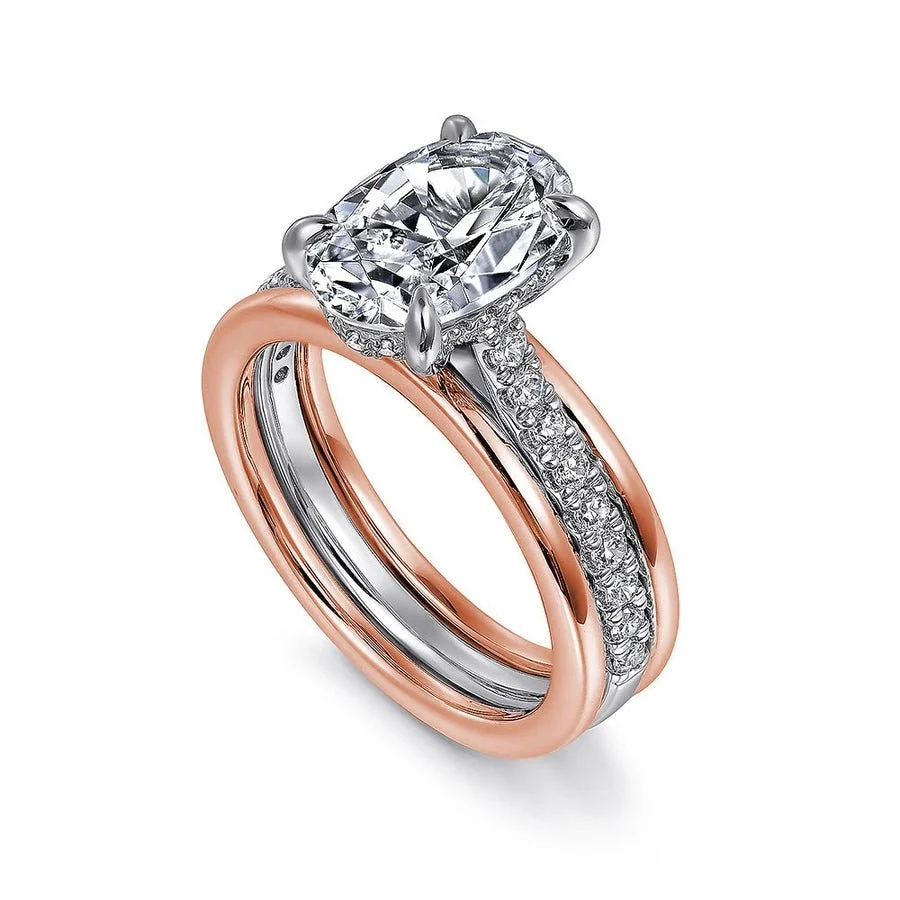 Two-tone rose gold oval moissanite engagement ring with hidden halo shown in stacked wedding set view