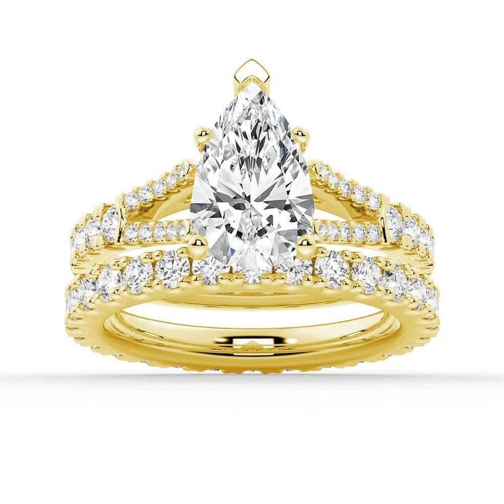 Yellow gold pear moissanite bridal set with pave engagement ring and matching wedding band