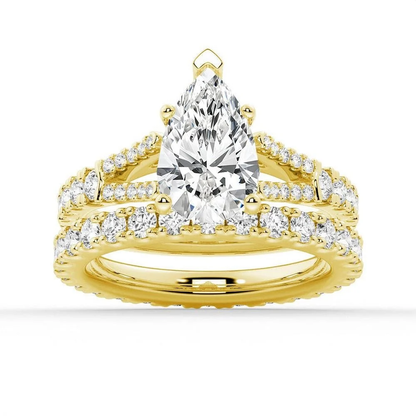 Yellow gold pear moissanite bridal set with pave engagement ring and matching wedding band
