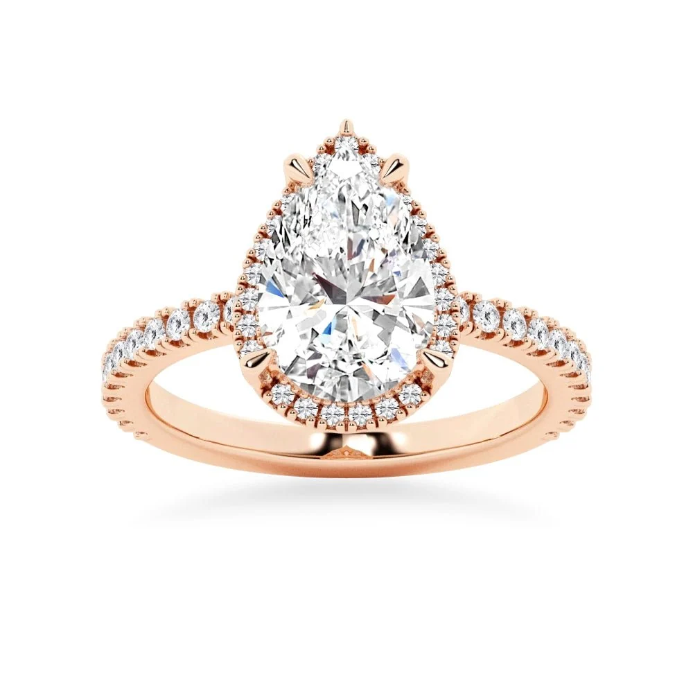 Rose gold pear cut moissanite engagement ring top view with sparkling halo and pave band