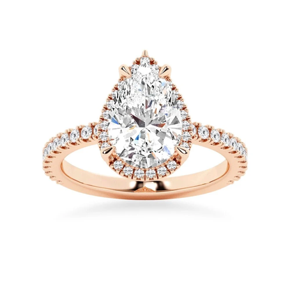 Rose gold pear cut moissanite engagement ring top view with sparkling halo and pave band
