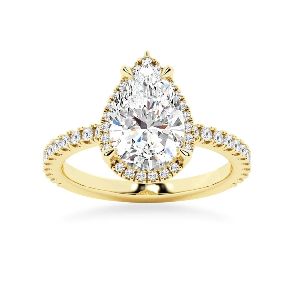 Yellow gold pear cut moissanite engagement ring top view with pave halo and side accent stones