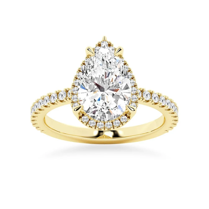 Yellow gold pear cut moissanite engagement ring top view with pave halo and side accent stones