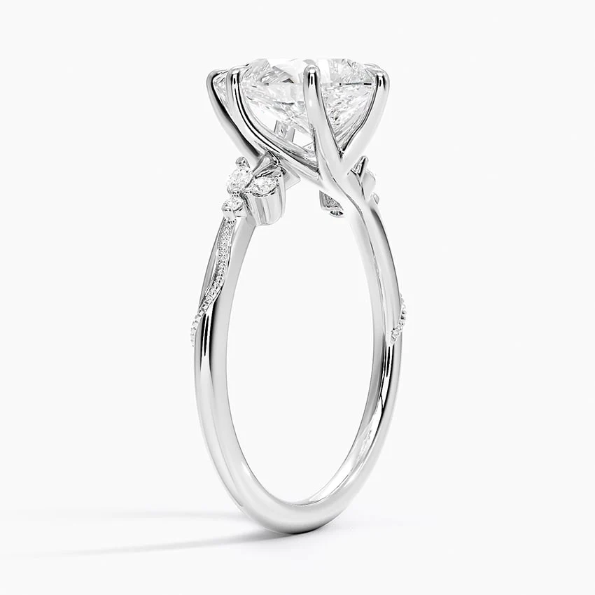 White gold pear-cut moissanite engagement ring 3/4 perspective view showing nature-inspired basket and slim band