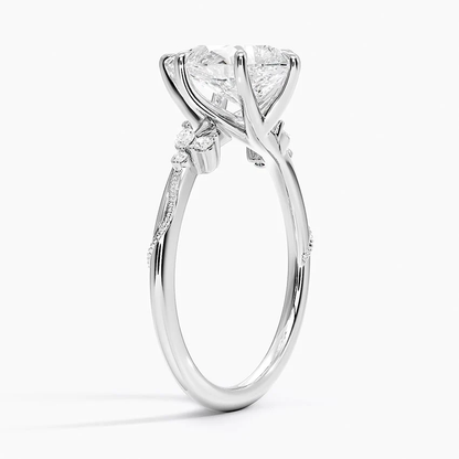 White gold pear-cut moissanite engagement ring 3/4 perspective view showing nature-inspired basket and slim band