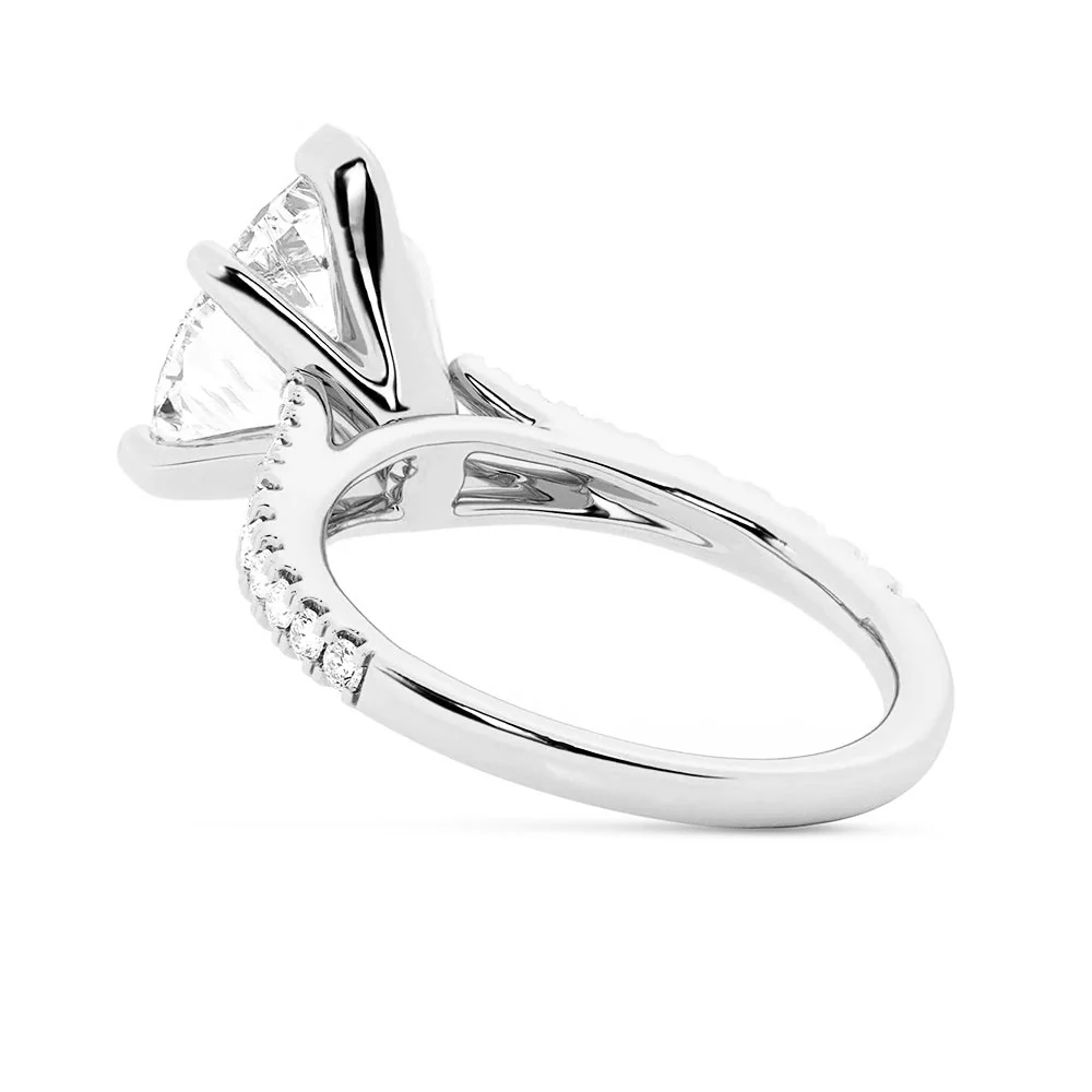 White gold pear-cut moissanite engagement ring direct side view showing split-shank junction