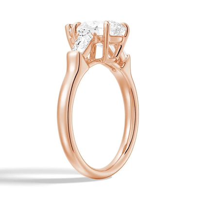 Rose gold pear moissanite engagement ring 3/4 perspective view displaying double claw prong setting