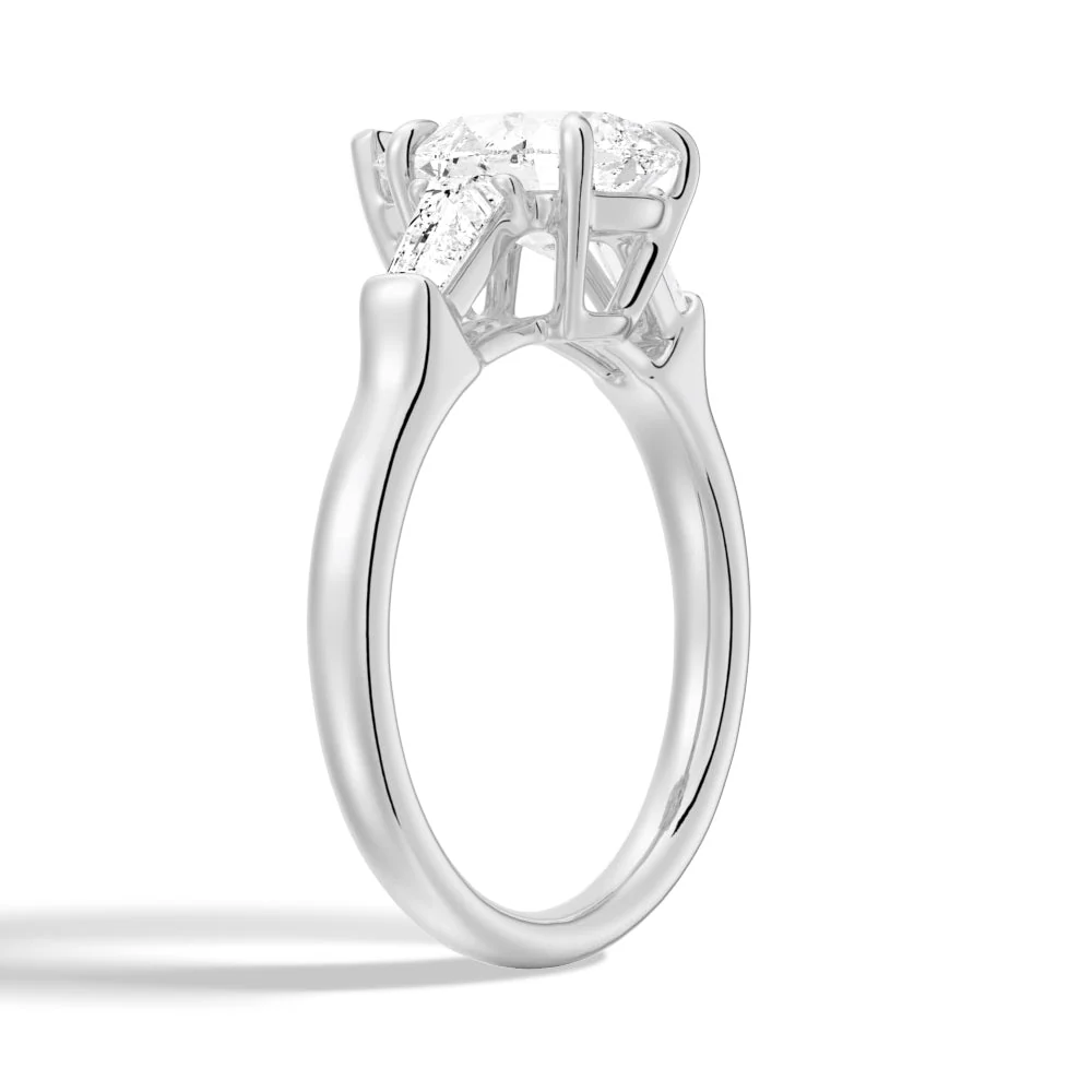 White gold pear moissanite engagement ring 3/4 perspective view highlighting double claw setting