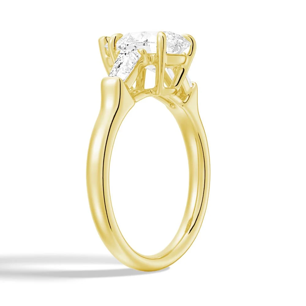 Yellow gold pear moissanite engagement ring 3/4 angle view showing double claw prongs
