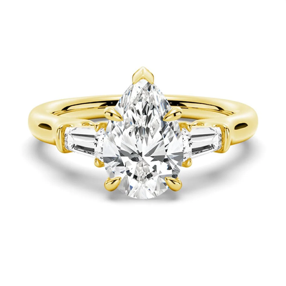 Yellow gold pear moissanite engagement ring top view featuring tapered baguette side diamonds