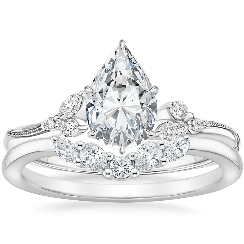 White gold pear-cut moissanite engagement ring paired with curved marquise wedding band bridal set top view
