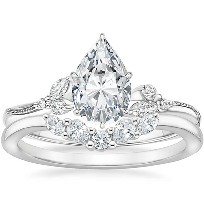 White gold pear-cut moissanite engagement ring paired with curved marquise wedding band bridal set top view