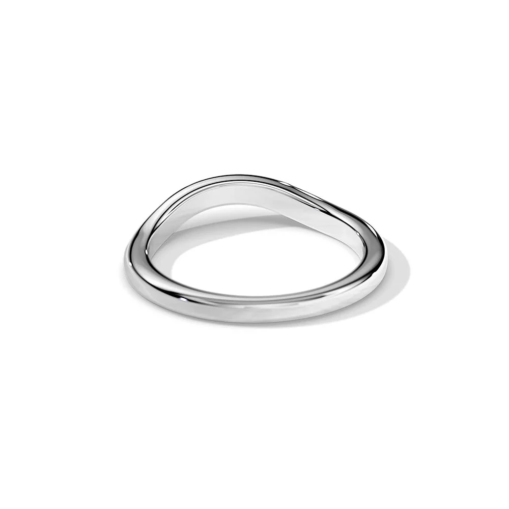 Angled view of white gold plain curved wedding band lying flat