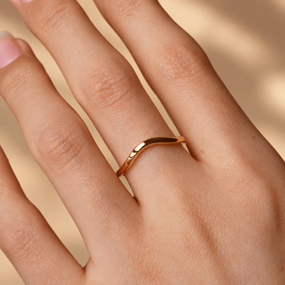 On-finger view of 1.6mm yellow gold high polish plain curved wedding band