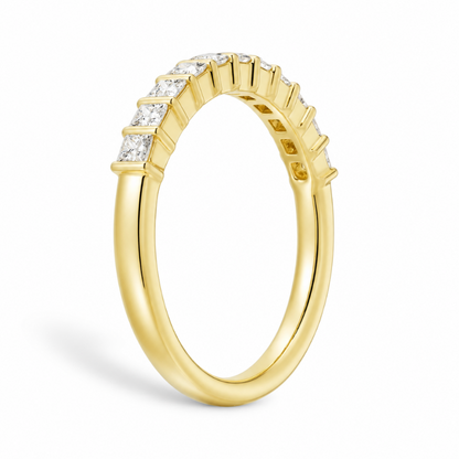 Three quarter angled view of yellow gold princess cut moissanite wedding band